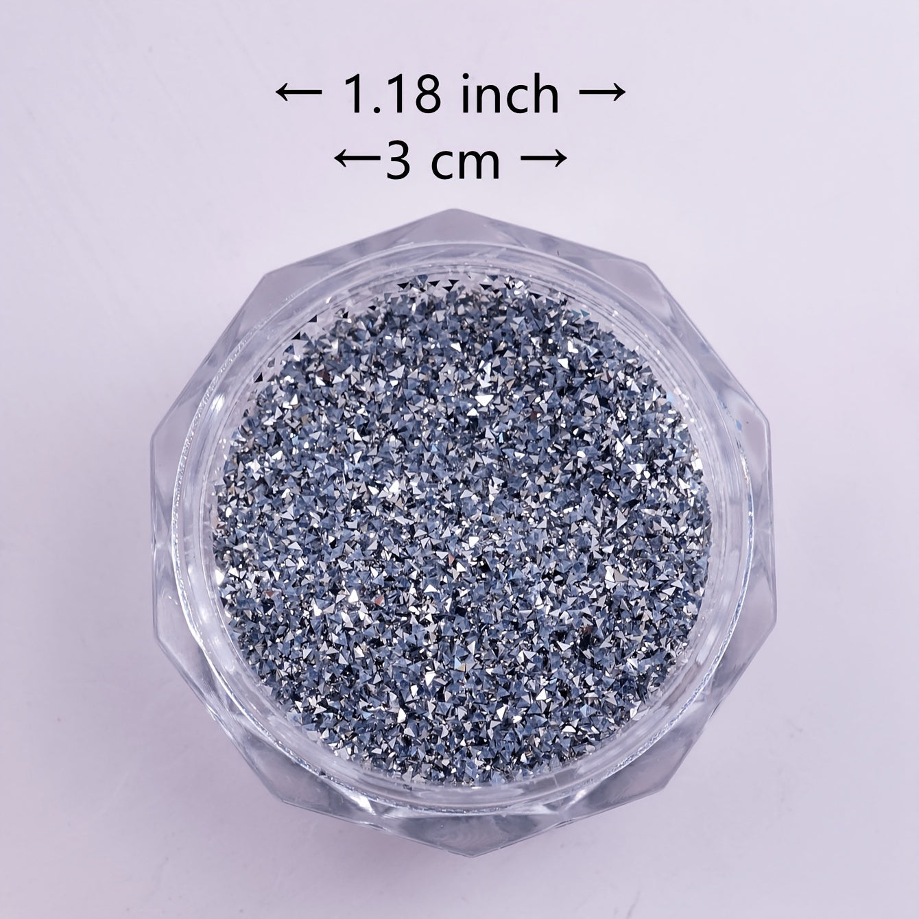 A Box of Tiny Silvery Triangular 3D Glittering Rhinestones, Perfect for Parties, Nightclubs, Music Festivals, And Vacation Nail Art Accessories.